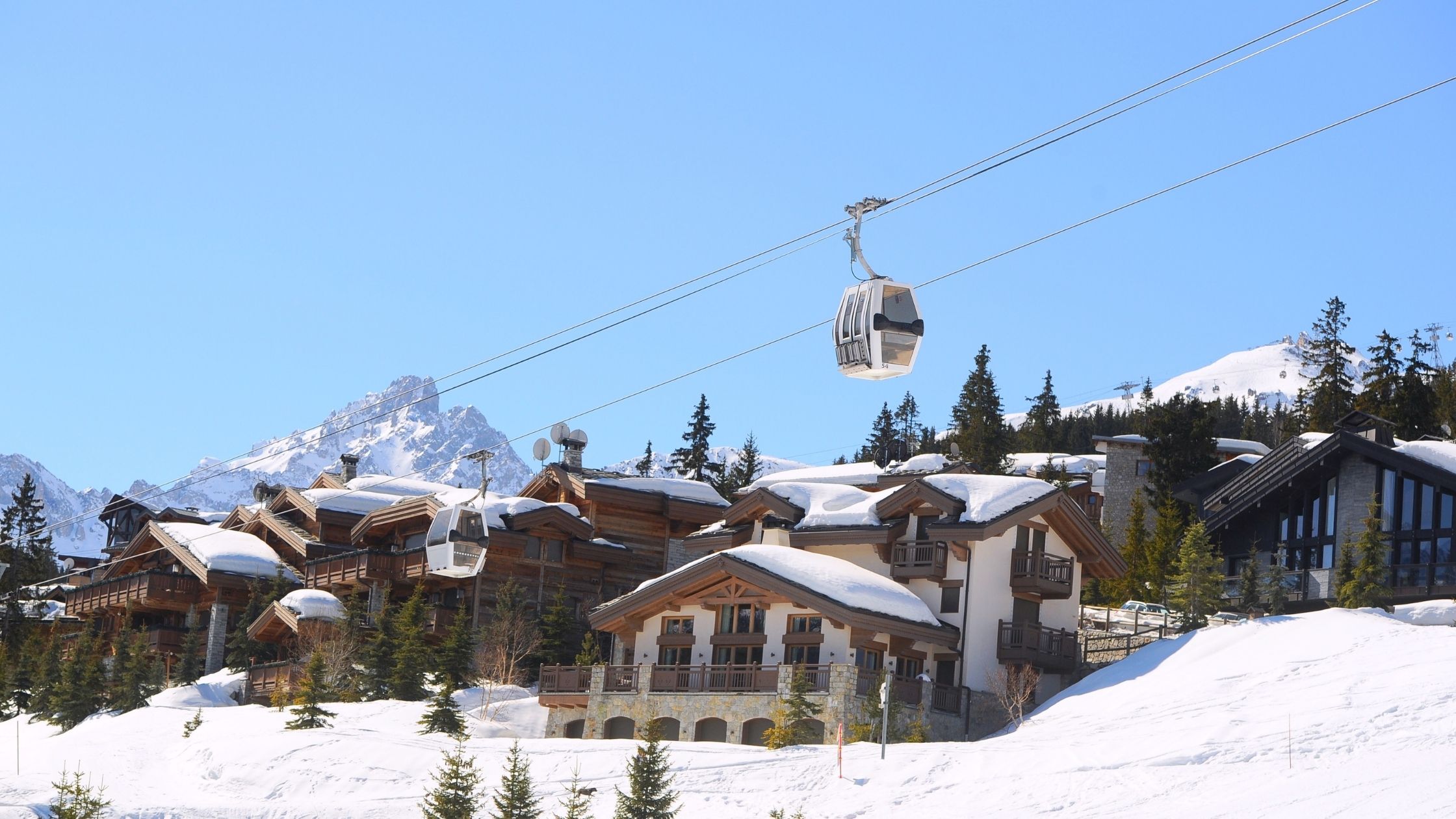 Ski resort in winter with chalets and ski lifts